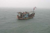 Vietnamese refugees escape on boat